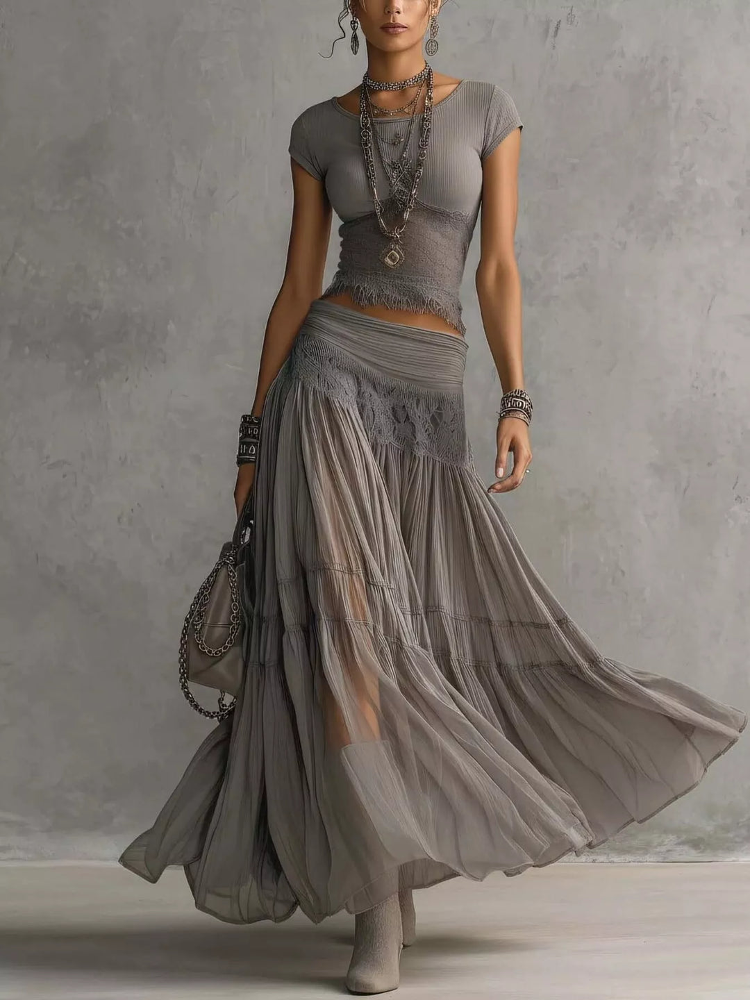 Women's skirt set in gray, lace top and tiered sheer maxi skirt, walking pose
