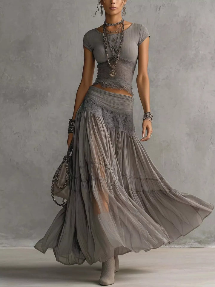 Women's skirt set in gray, lace top and tiered sheer maxi skirt, walking pose