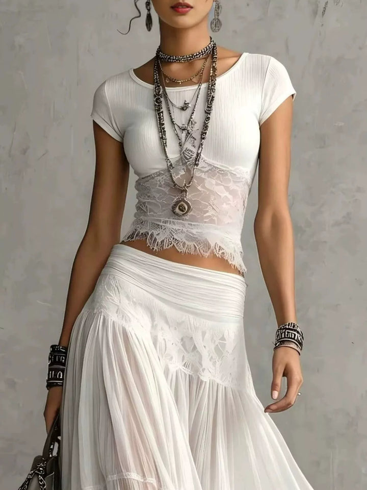 White fitted tee with lace panel and tiered maxi skirt waist, close view
