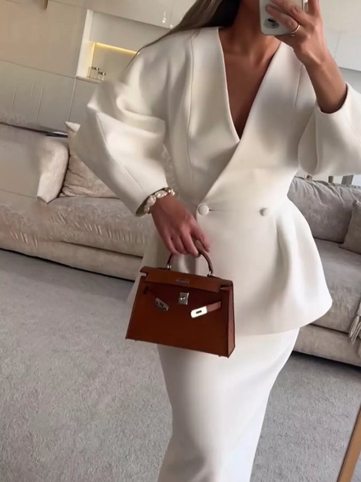 White skirt suit with V neck blazer and puff sleeves, front view