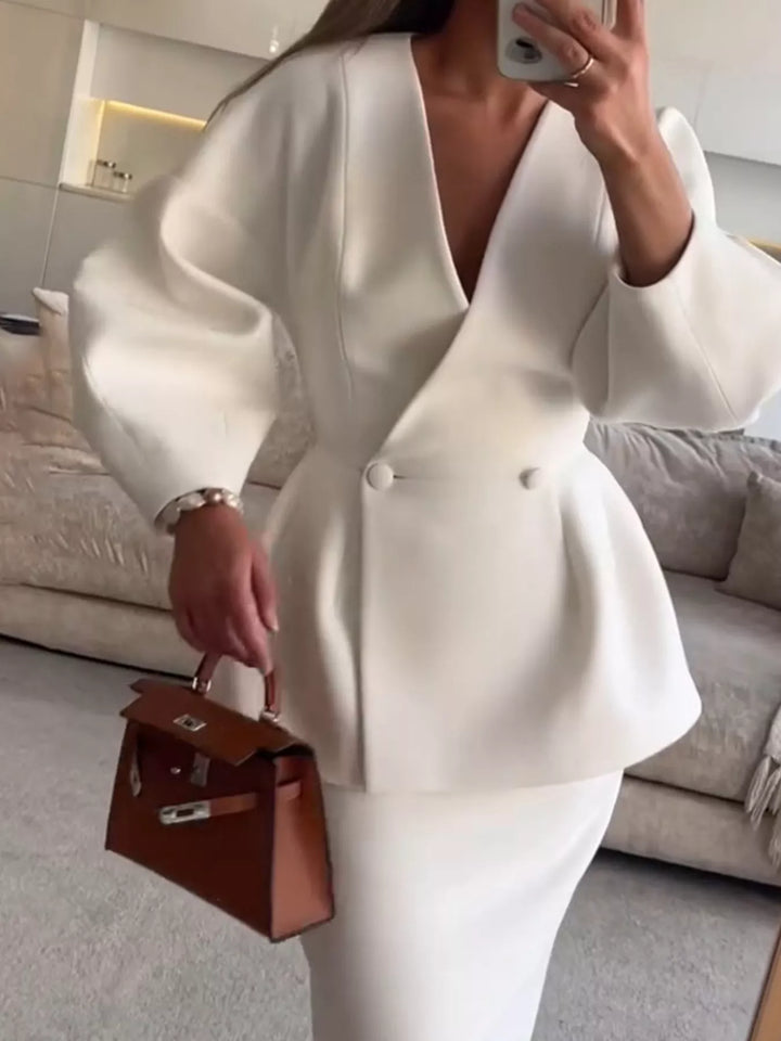 White peplum blazer and pencil skirt set worn with a brown handbag