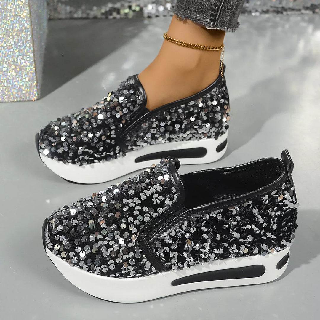 Pair of black sequin platform slip on sneakers shown from the side and top