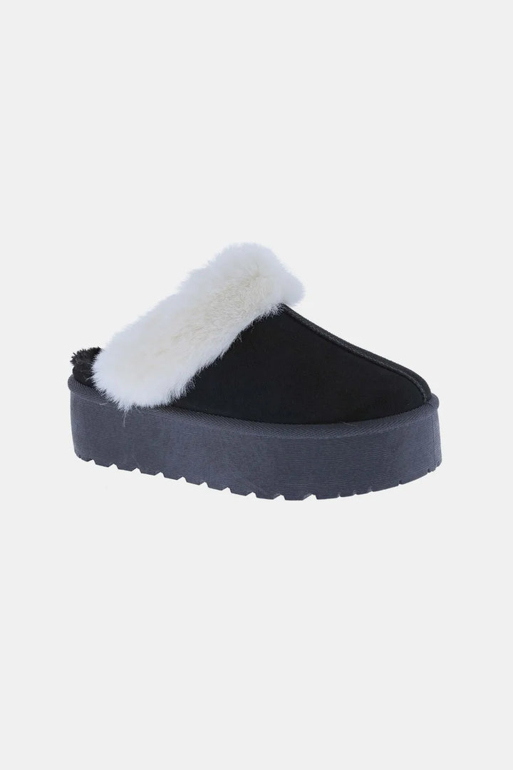 Women's slippers in black, platform slip on clog with plush trim, side view