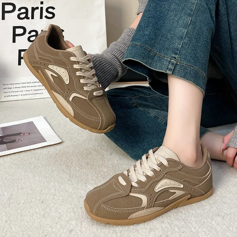 Camel retro lace up sneakers worn with rolled jeans and gray socks