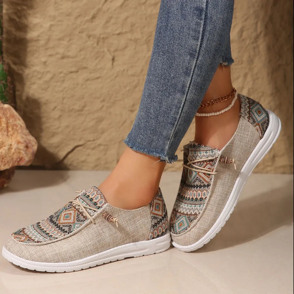 Khaki Aztec print round toe sneakers, side view with rolled jeans
