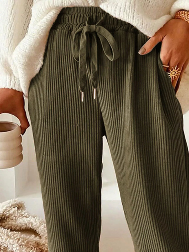 Close-up of the olive ribbed pants drawstring tie and pocket