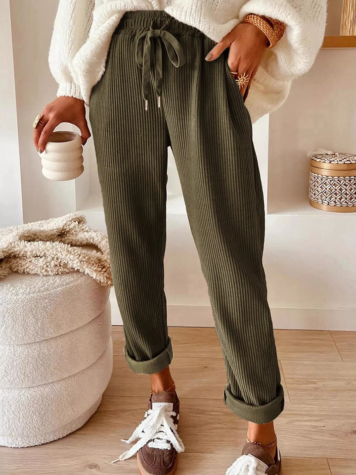 Olive ribbed straight leg pants with drawstring, worn with cream knit top