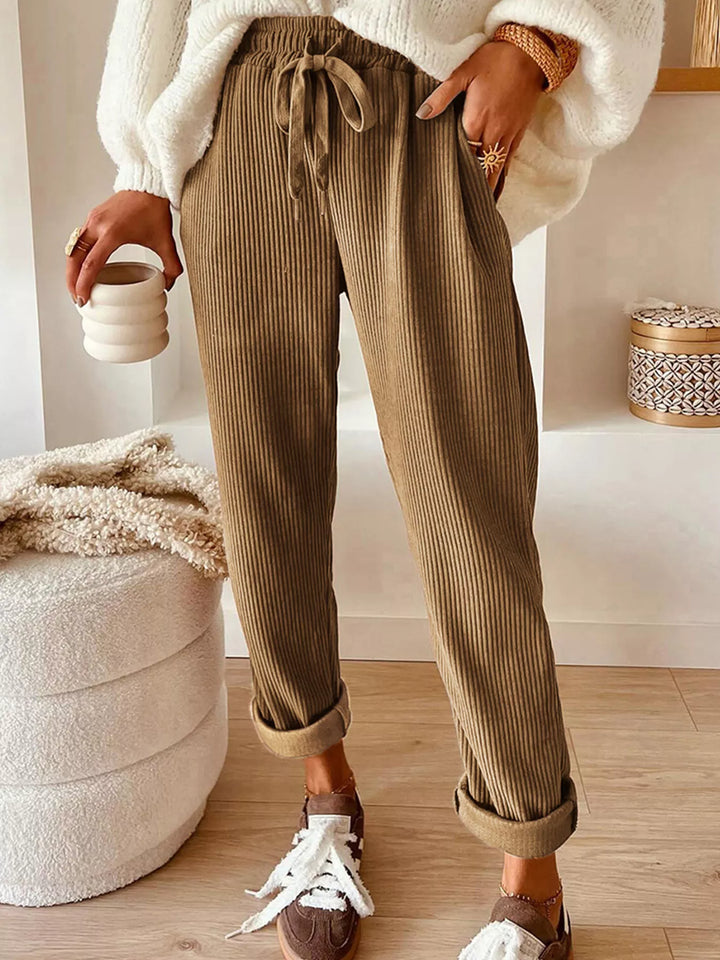 Tan ribbed straight leg pants with drawstring waist, worn with a cream sweater