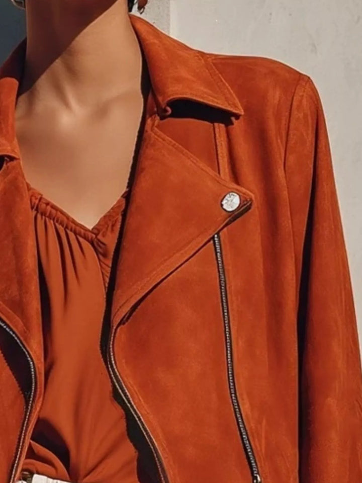 Cropped moto fringe hem asymmetric zip in rust, close-up detail