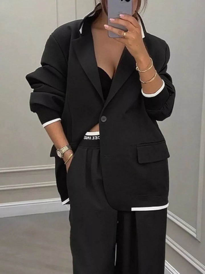 Oversized one button blazer and wide leg pants in black, close-up detail