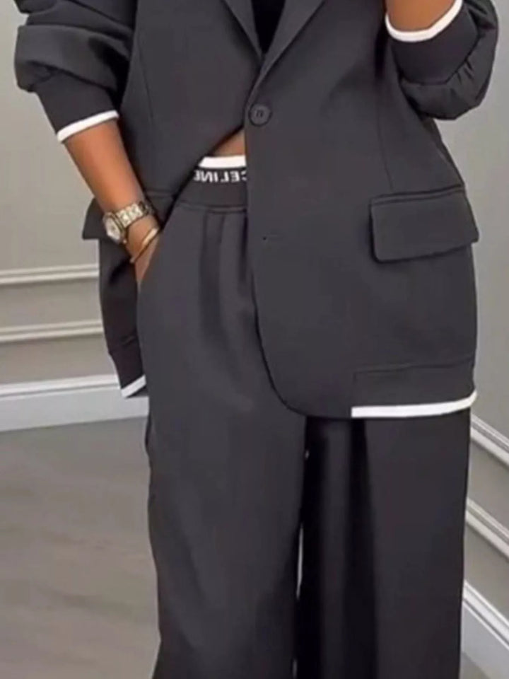Oversized one button blazer and wide leg pants in dark gray, close-up detail