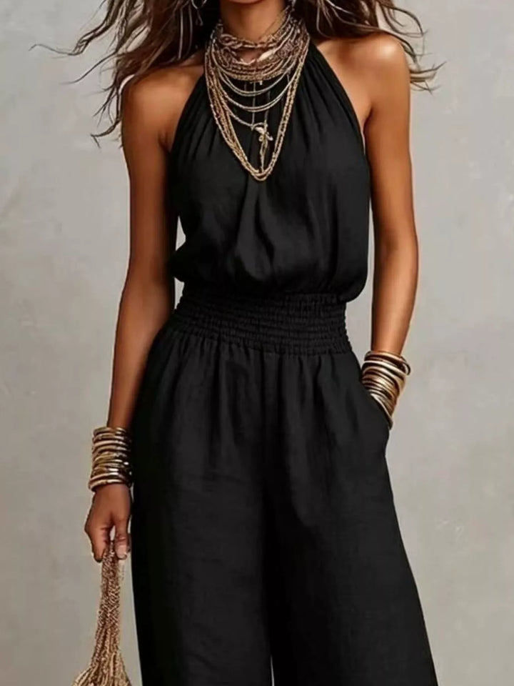 Black wide leg jumpsuit, close view of the halter neck and smocked waist