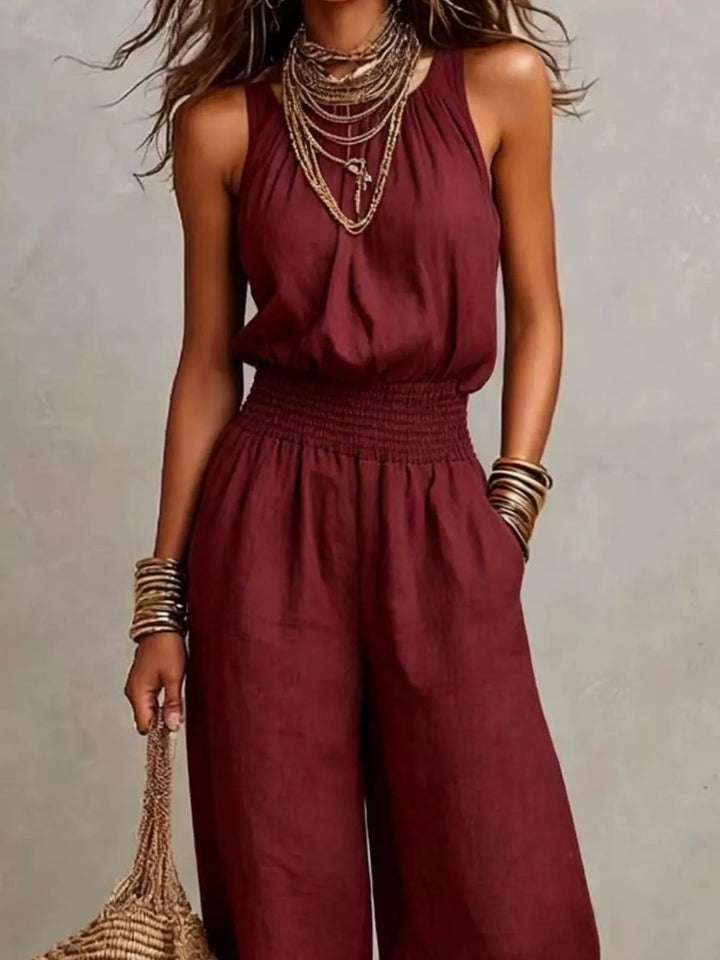 Burgundy halter neck jumpsuit, closer view of the smocked waist