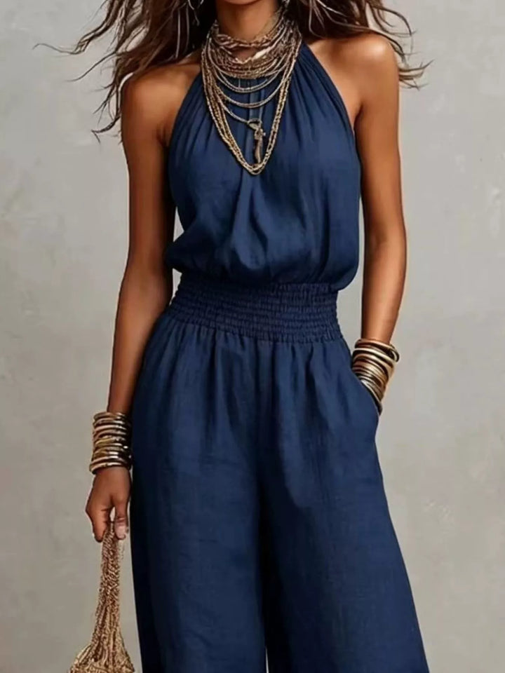 Navy wide leg jumpsuit, closer view of the smocked waist