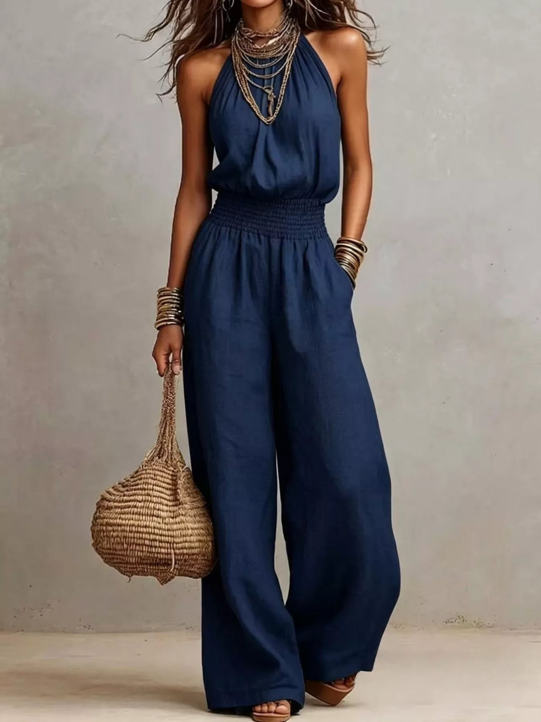 Navy halter neck summer jumpsuit with wide leg and bangles