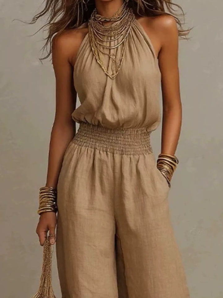 Tan summer jumpsuit, close view of the halter neck and smocked waist