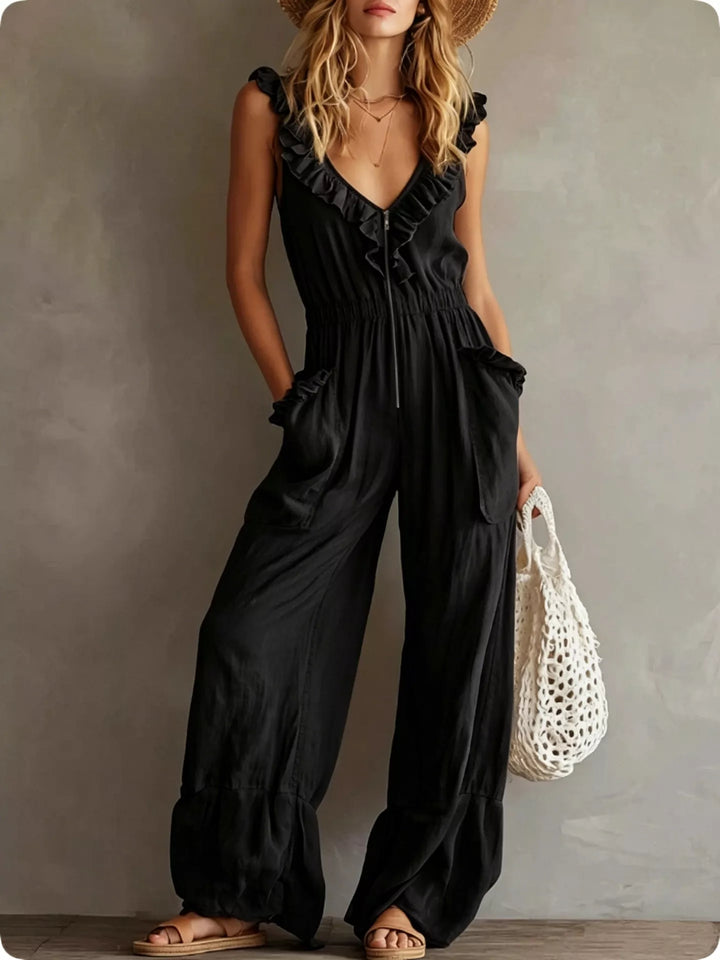 Black ruffle V neck jumpsuit with wide legs, front view with straw hat