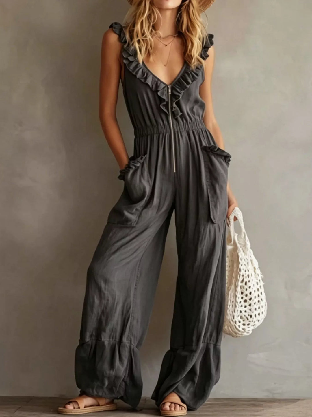 Charcoal sleeveless ruffle V neck jumpsuit with wide legs, front view
