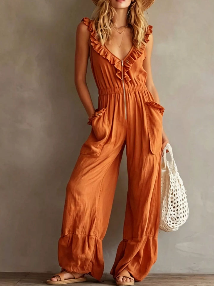 Orange wide leg jumpsuit with ruffle V neck and side pockets, front view
