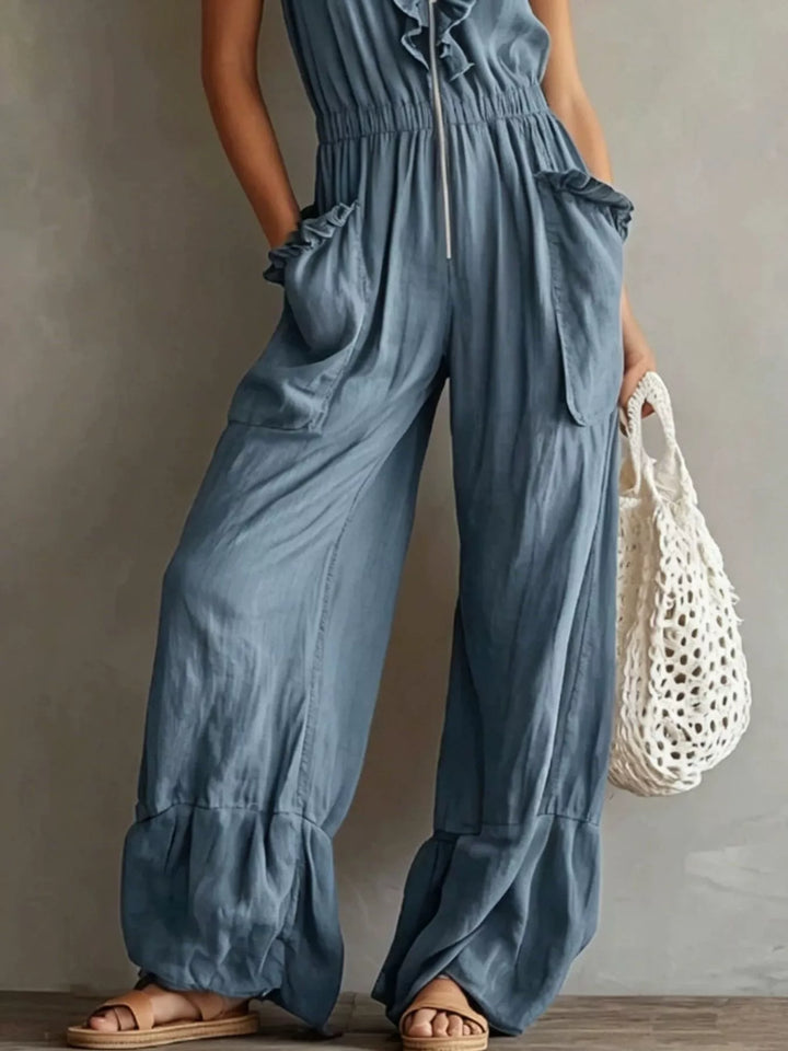 Steel blue jumpsuit lower view with wide leg pants and gathered hem