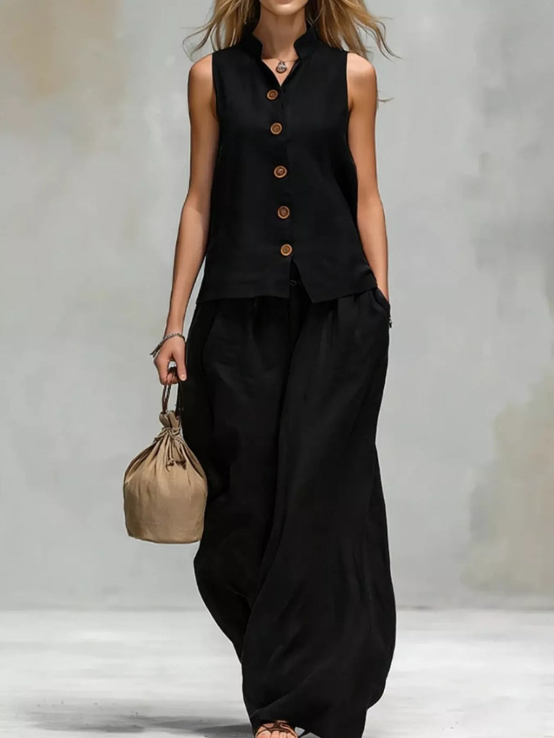 Black sleeveless vest and wide leg pants set, full length view with a tote