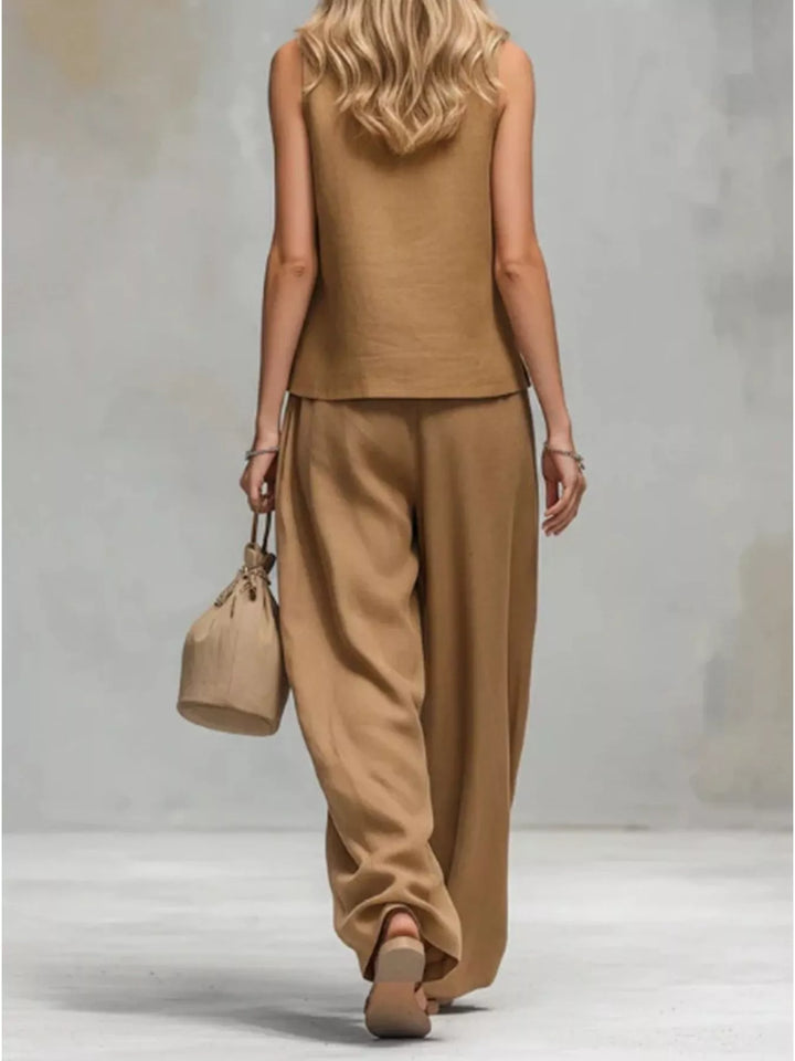 Back view of the camel sleeveless vest and wide leg pants while walking