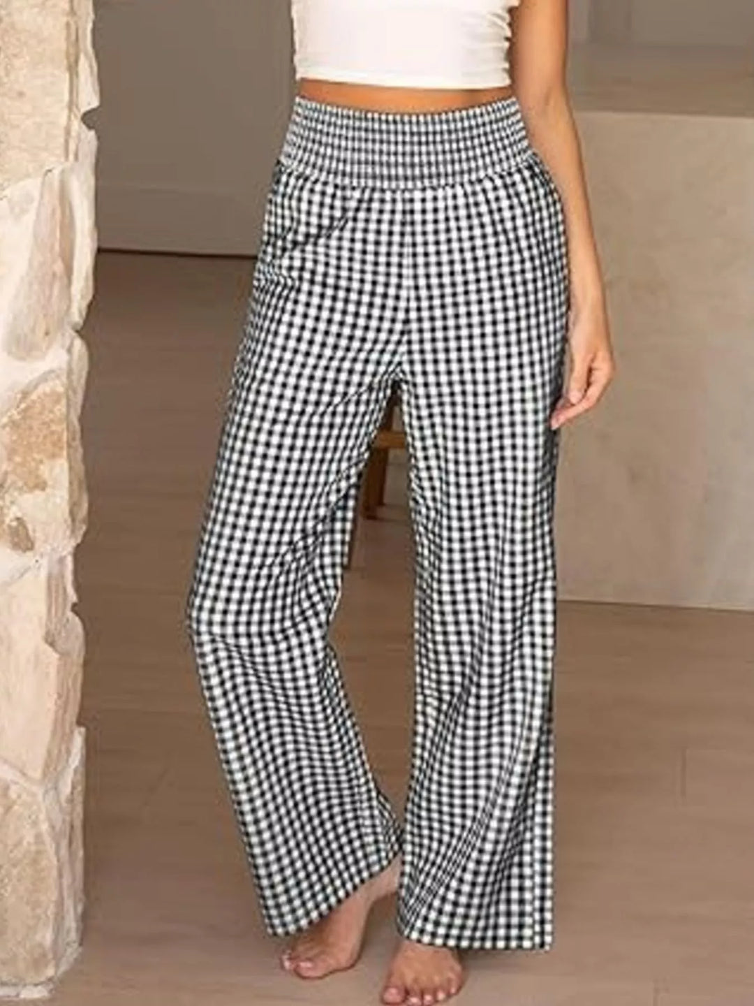 Black gingham wide leg pants walking forward with a white crop top
