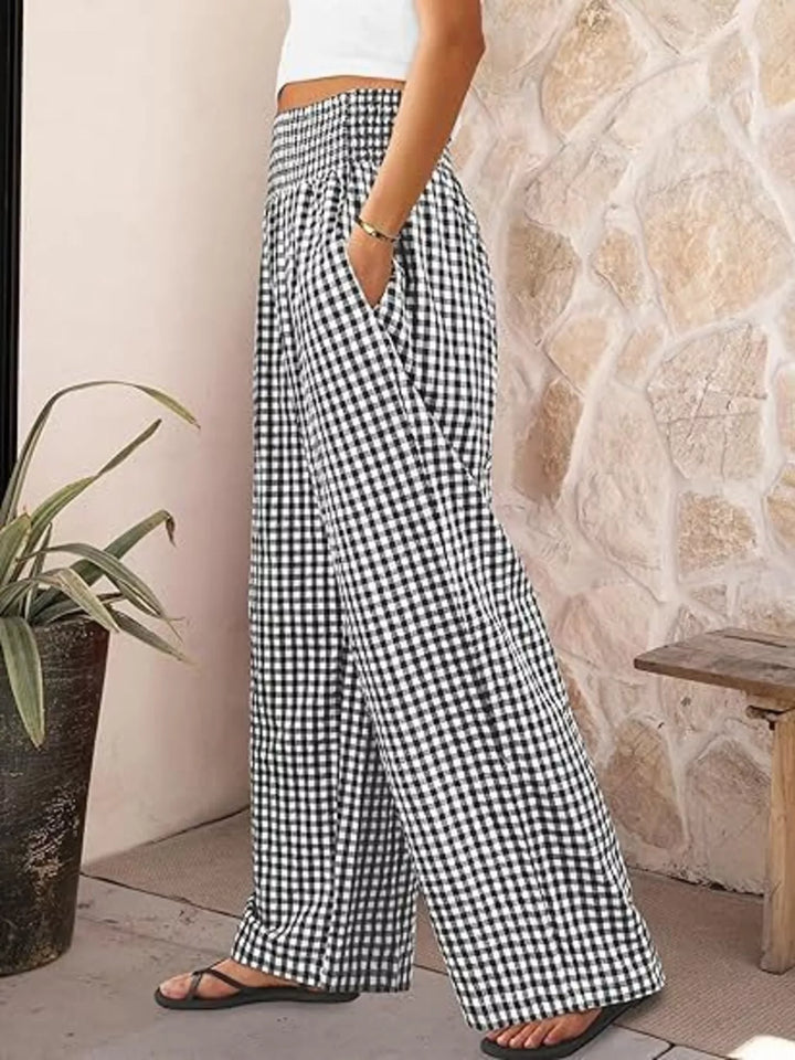 Black gingham smocked waist pants in side view with sandals