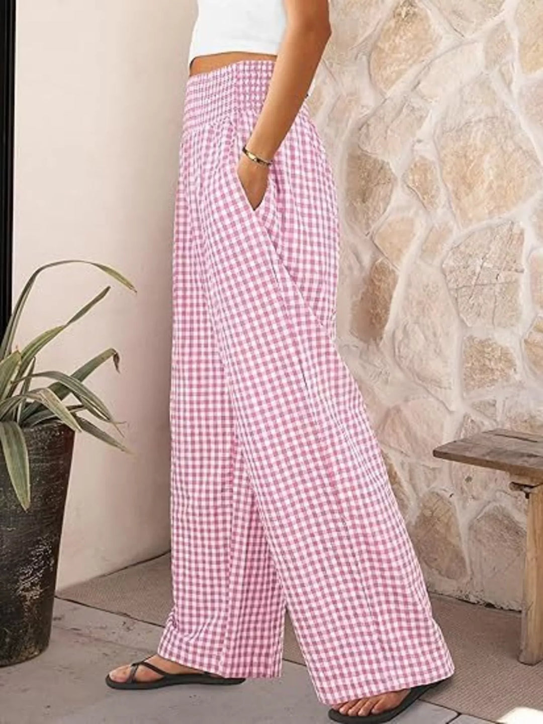 Pink gingham wide leg pants in side view with sandals