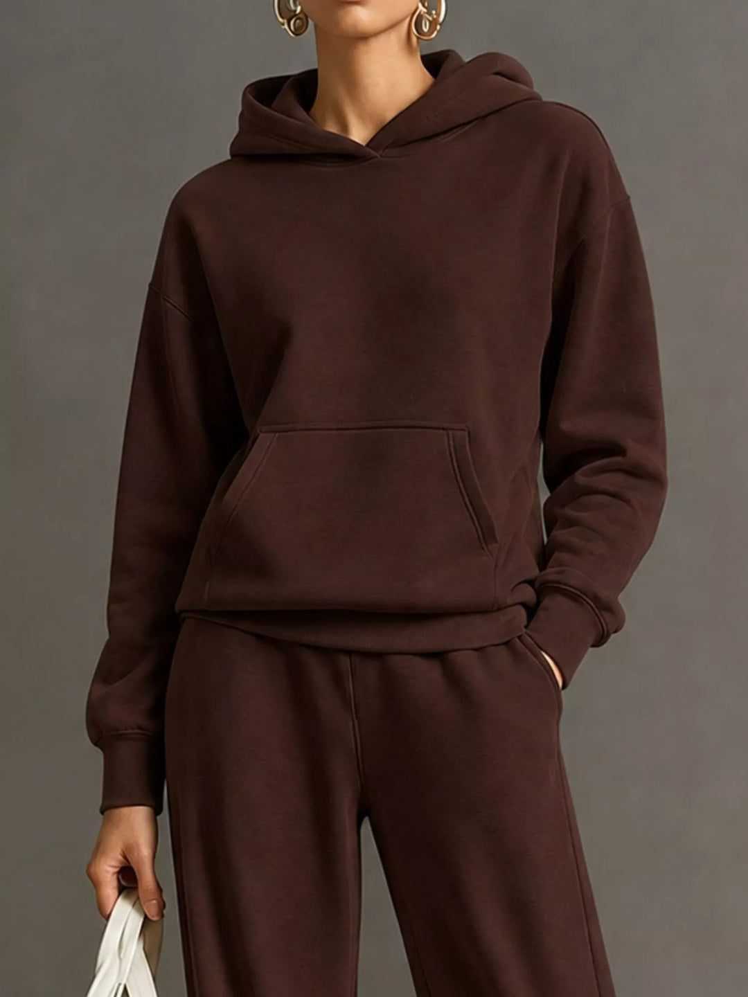 Kangaroo pocket hoodie and wide leg pants in dark brown, close-up detail