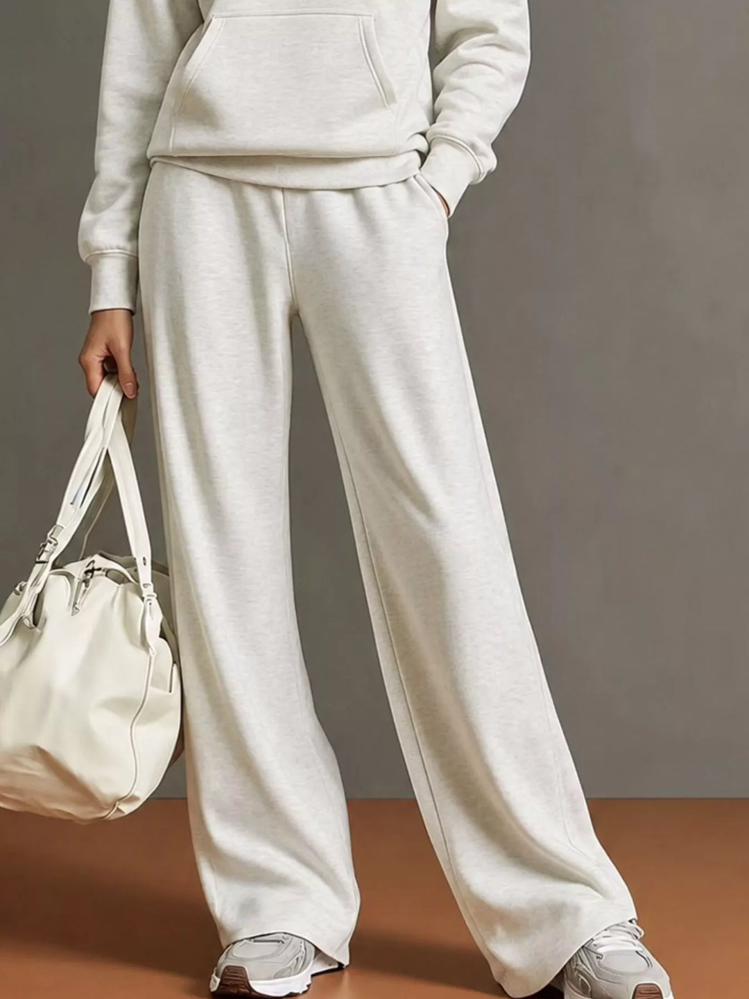 Kangaroo pocket hoodie and wide leg pants in white, close-up detail 2