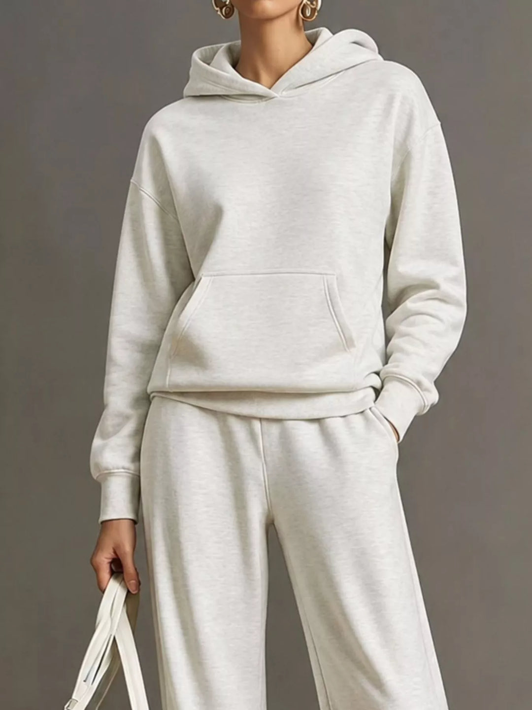 Kangaroo pocket hoodie and wide leg pants in white, close-up detail