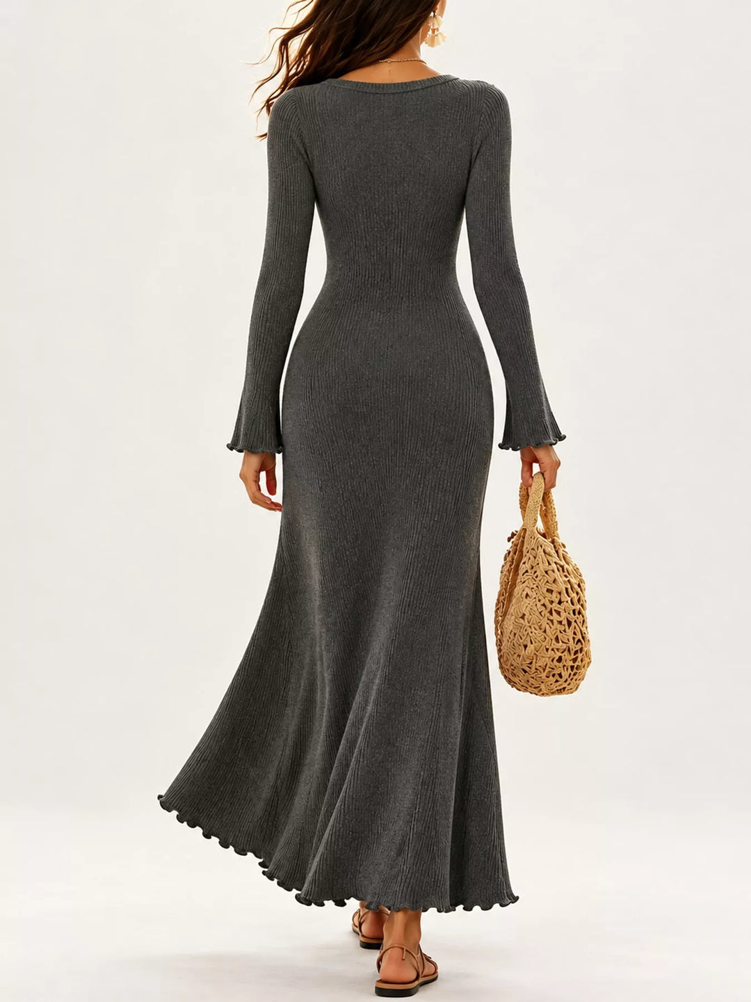 Gray sweater dress worn on a model, showing the flared sleeves