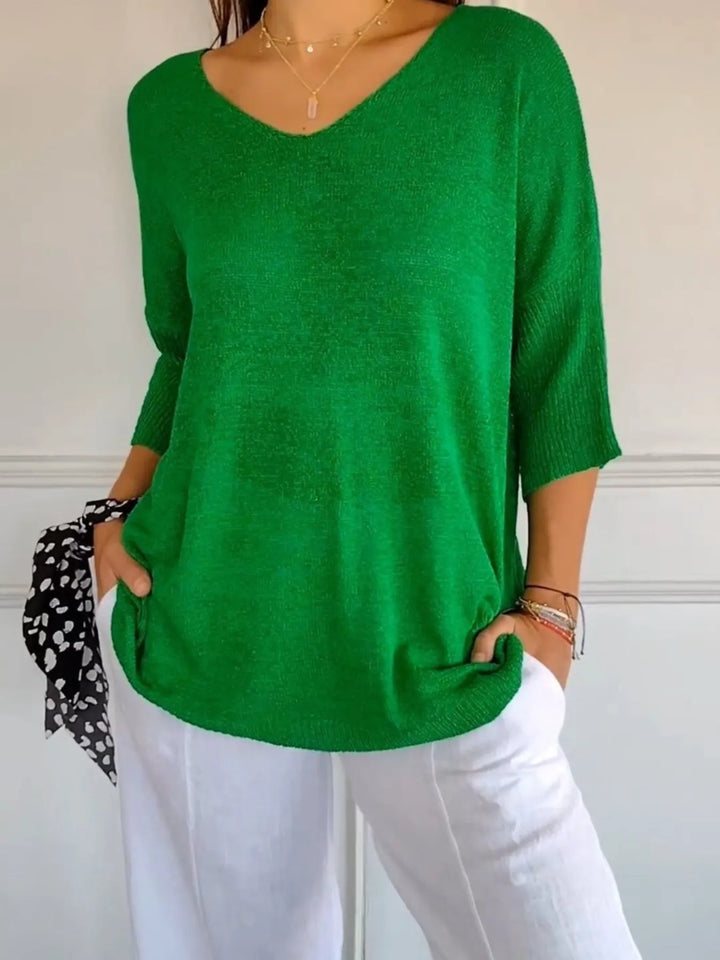 Green lightweight V neck sweater with 3/4 sleeves, styled with white pants