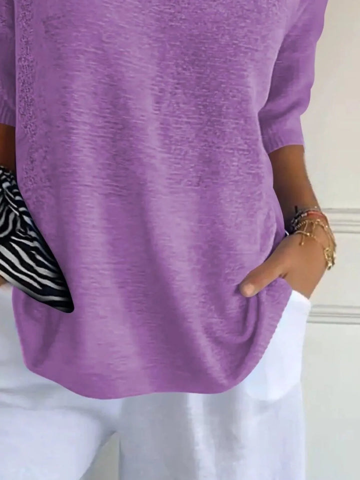 Close-up of the lilac V neck sweater with a zebra print scarf tied at the waist