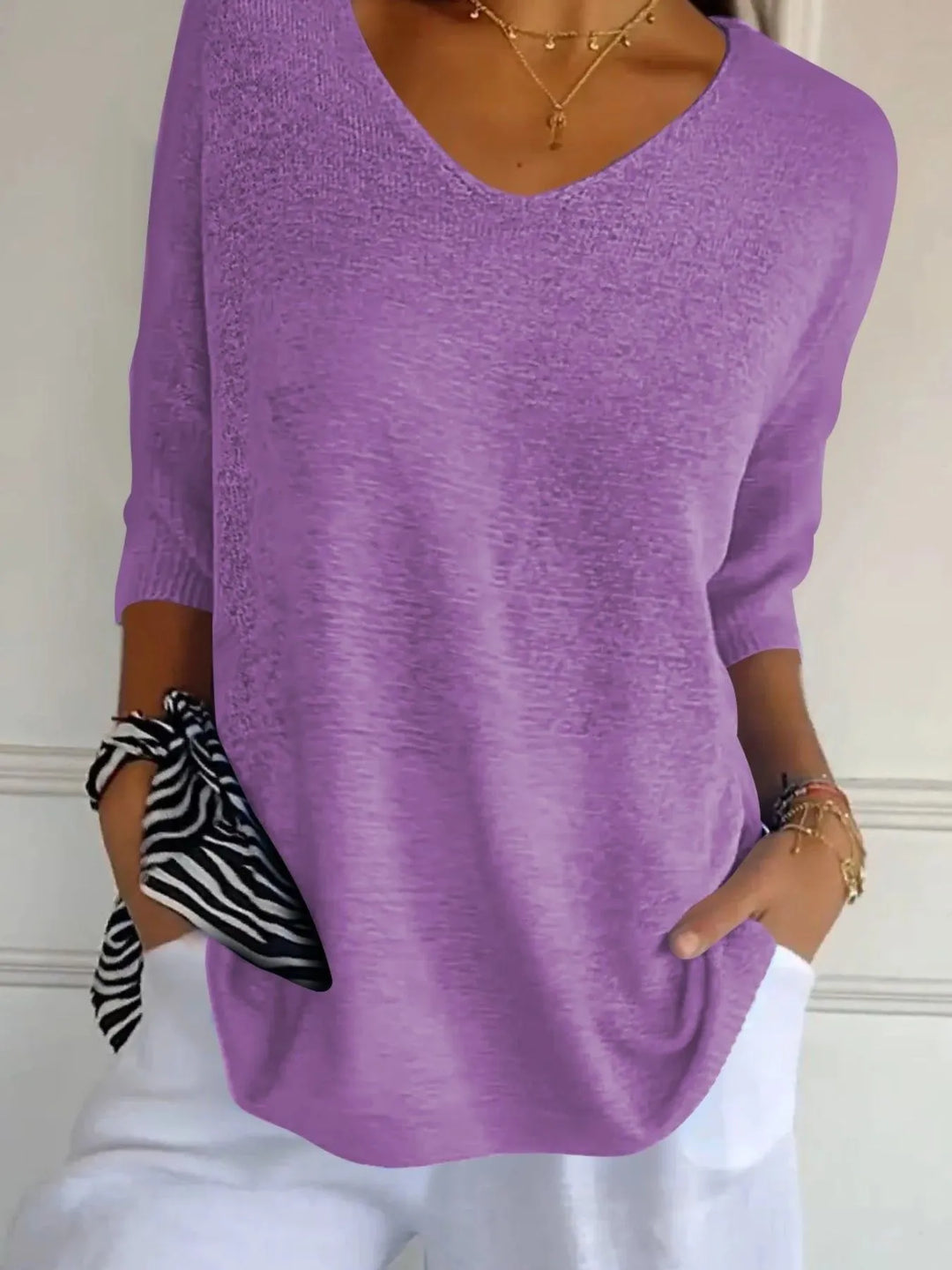 Women's sweater in lilac, lightweight V neck with 3/4 sleeves, worn with white pants