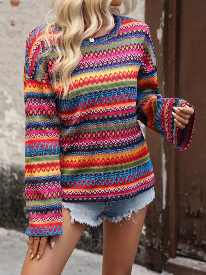 Red zigzag stripe sweater with bell sleeves, side angle with raised arm