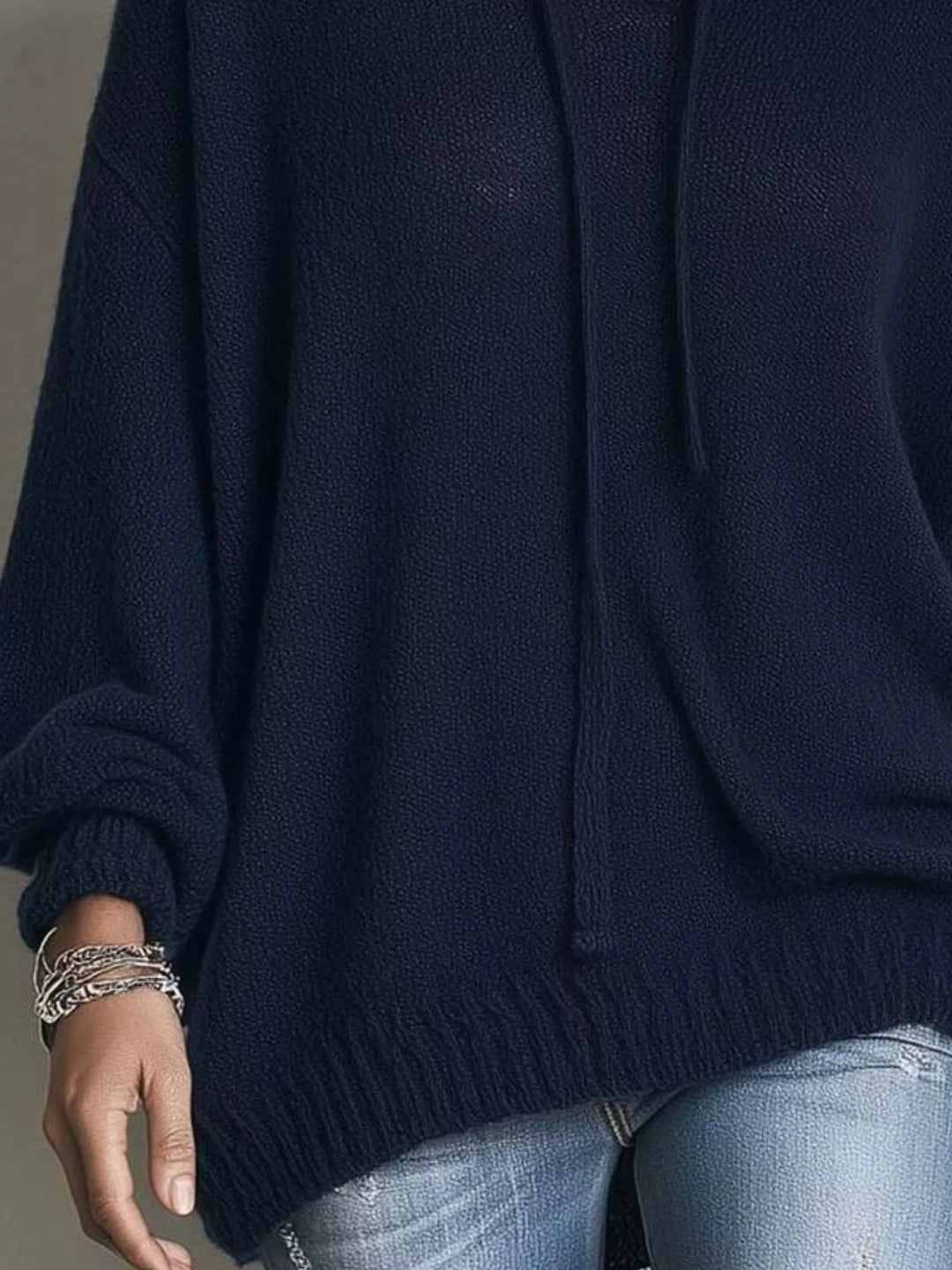 Detail of the navy sweater sleeve and ribbed hem