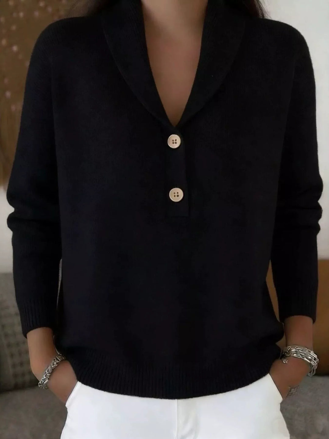 Black shawl collar sweater with button placket, front view with hands in pockets