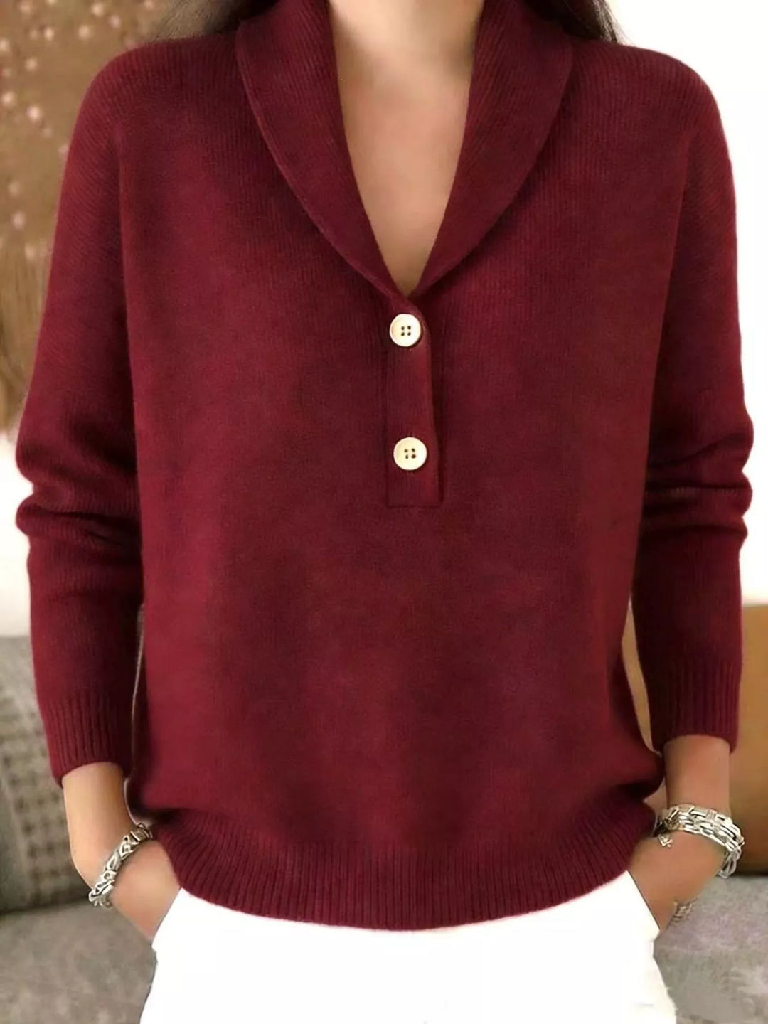 Burgundy sweater with shawl collar V neck and two buttons, worn with white pants