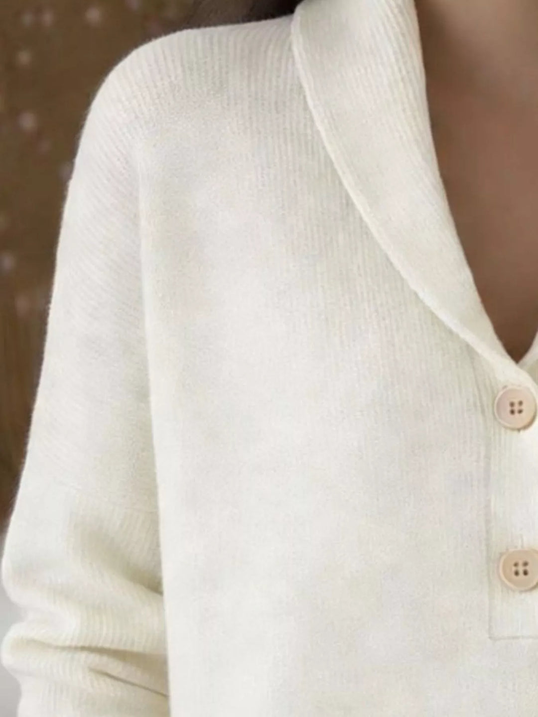 Close-up of the cream sweater shawl collar and buttons