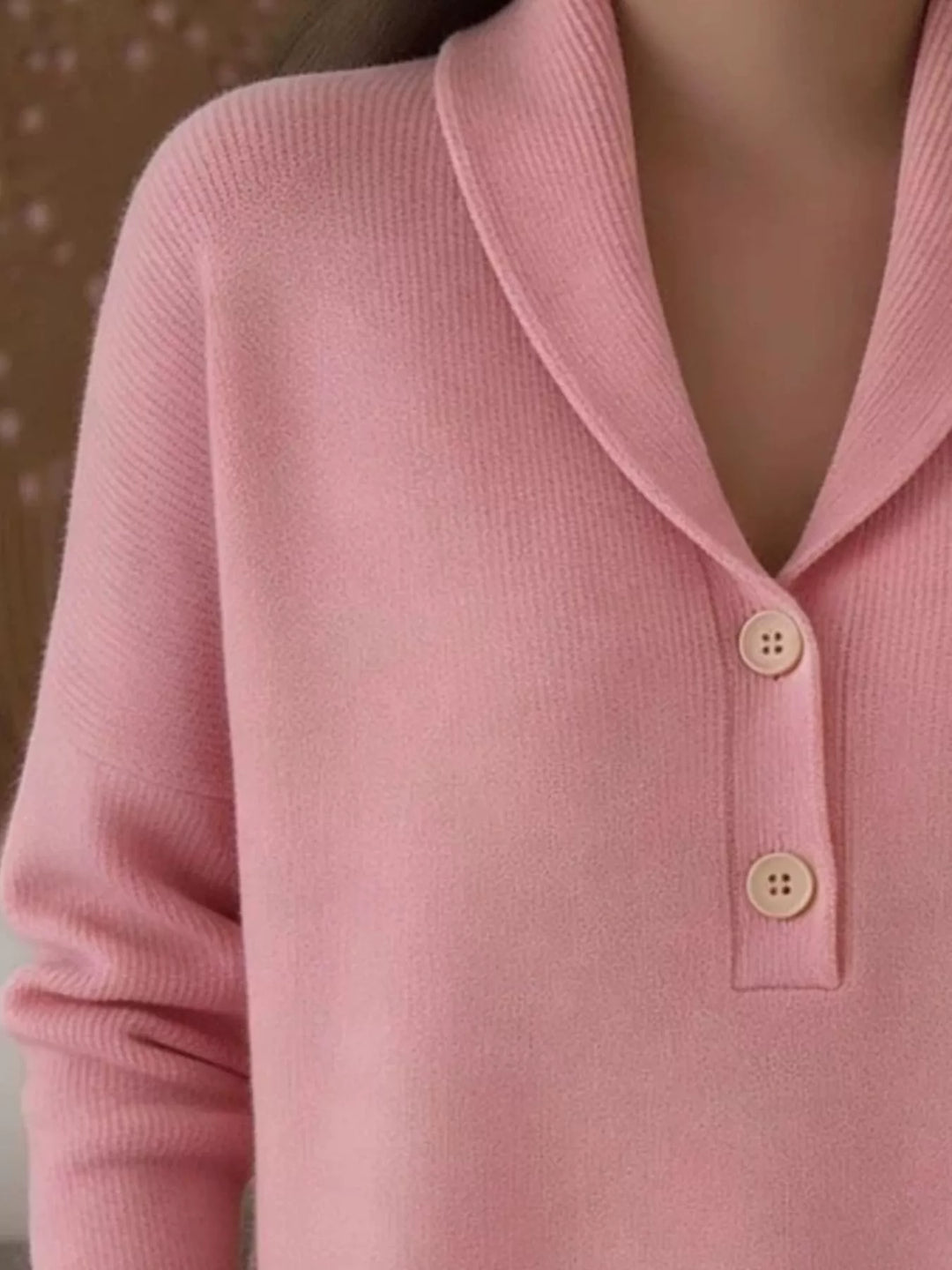 Close-up of the pink sweater shawl collar and two button placket