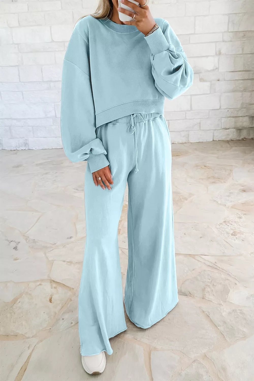Women's sweatsuit in pastel blue, cropped pullover and wide leg drawstring pants, front