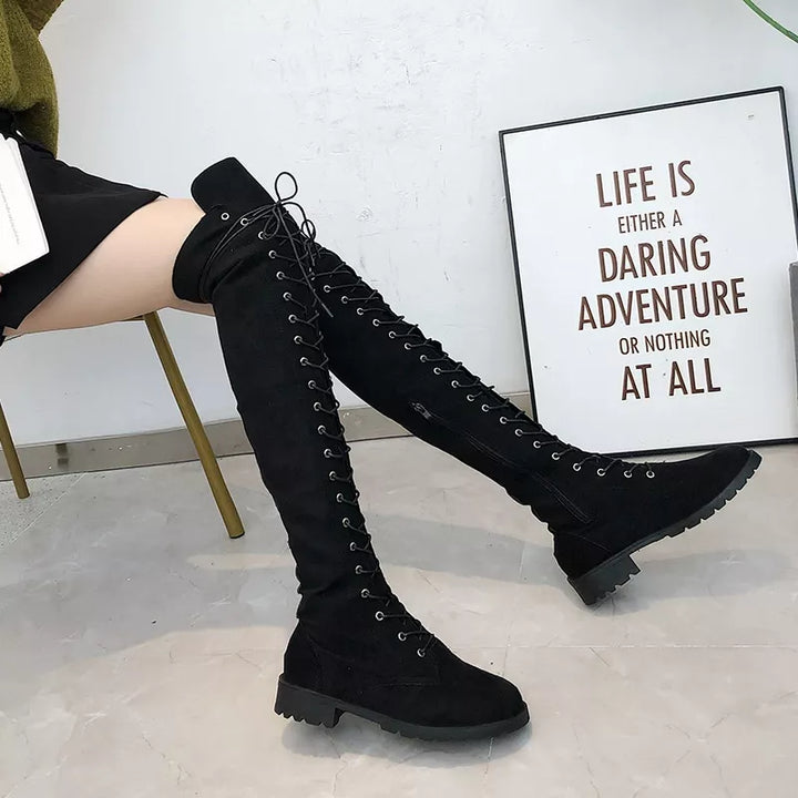 Side view of black thigh high lace up boots with low block heel