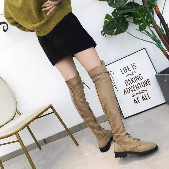 Full-length view of camel thigh high boots with an olive sweater