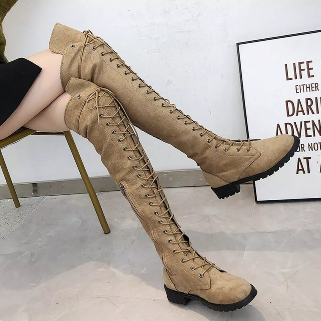 Camel over the knee lace up boots worn seated with legs extended