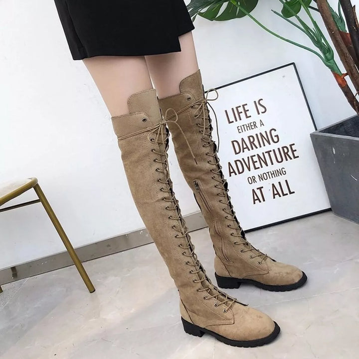 Camel lace up boots styled with a black mini skirt