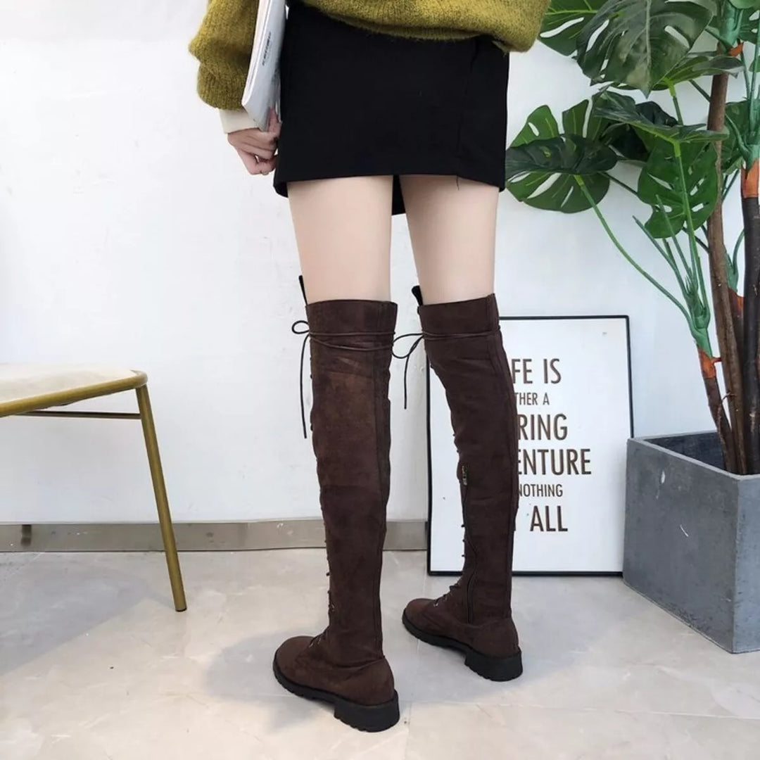 Back view of dark brown thigh high boots with lace detail