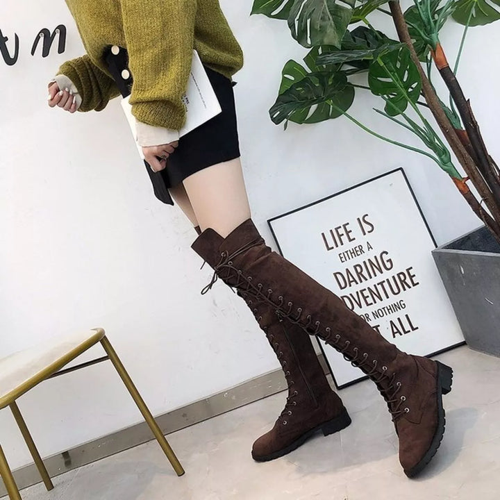 Full-length view of dark brown lace up boots with a mustard sweater