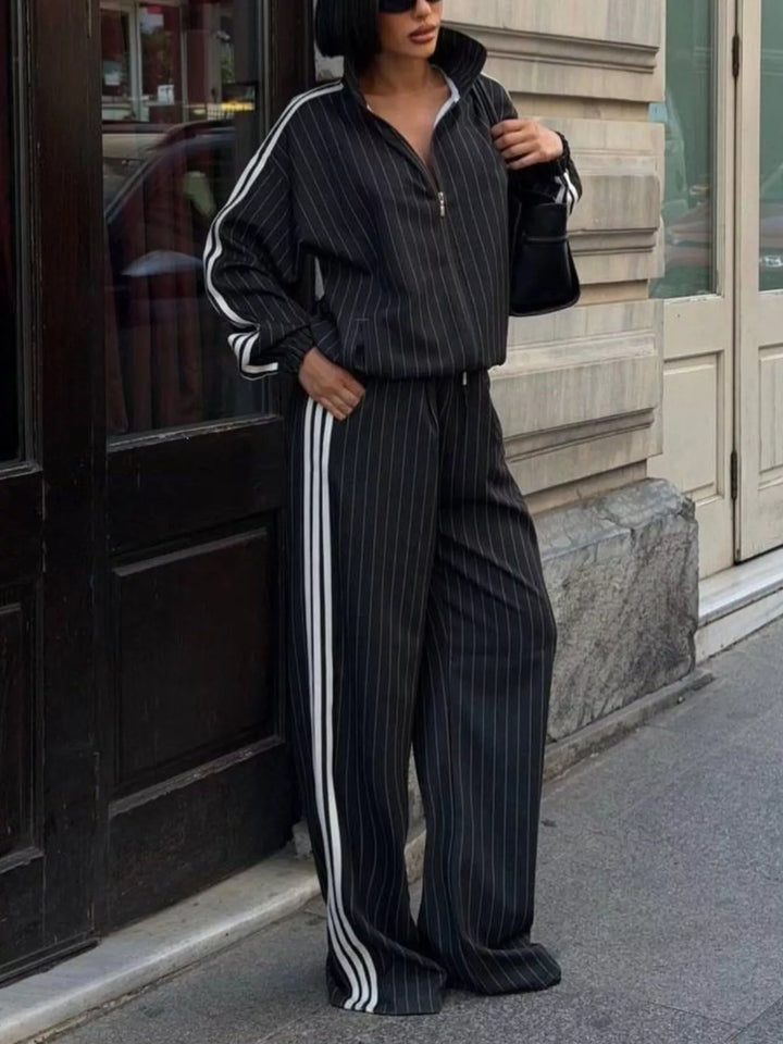 Black pinstripe track jacket with high collar and side striped wide leg pants